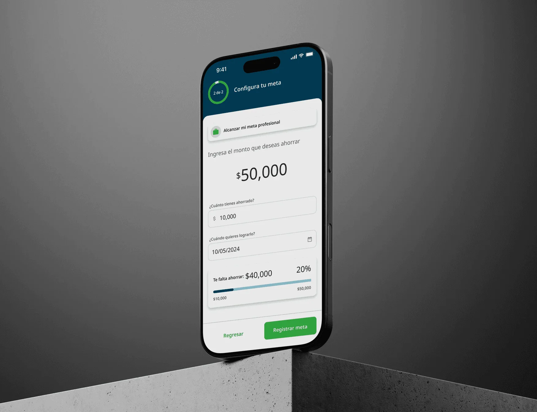 Pantalla móvil para configurar una meta de ahorro (paso 2 de 2). El usuario tiene como objetivo $50,000 MXN para una meta profesional, con $10,000 ahorrados y fecha objetivo del 10 de octubre de 2024. Una barra de progreso muestra el 20% alcanzado, con $40,000 restantes. Se muestra un botón de "Registrar meta".